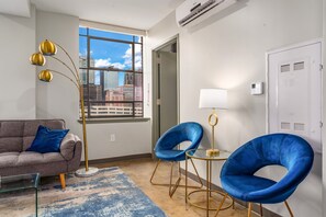 Cozy seating area with bold colors, large windows, and a relaxing vibe.