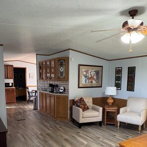 Spacious living room leading to kitchen 