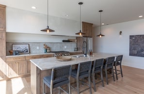 Upscale kitchen with large kitchen island with dining area
