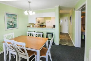 A cozy and well-equipped dining area and kitchen provide a welcoming space for family meals and gatherings.