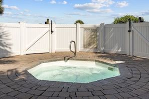 Relax in the serene hot tub area, enclosed for privacy, offering a peaceful retreat after a day of fun under the sun.