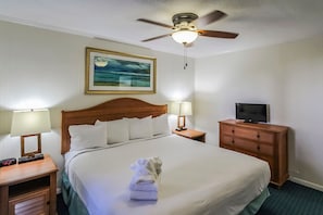 Retreat to a cozy bedroom featuring convenient amenities and a calming ambiance, making it a perfect place to relax after a day of exploring nearby attractions like Fort Macon.