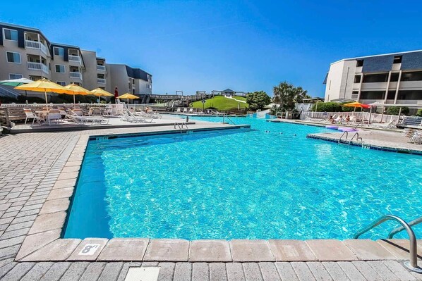 Dive into relaxation with shimmering indoor/outdoor pools, a soothing hot tub, and easy access to the beach, all complemented by a full kitchen for effortless dining after a day of adventure near Fort Macon.