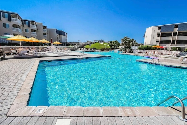 Dive into relaxation with shimmering indoor/outdoor pools, a soothing hot tub, and easy access to the beach, all complemented by a full kitchen for effortless dining after a day of adventure near Fort Macon.