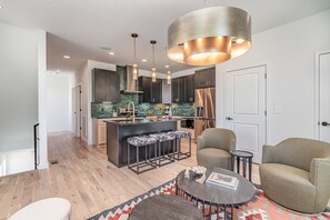Open-floor living space featuring a smart TV and designer furnishings. (2nd Floor)