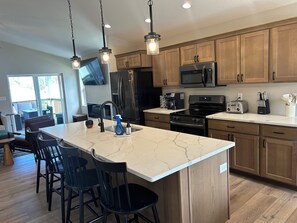 Kitchen with large island and fully equipped for all of your cooking needs.  