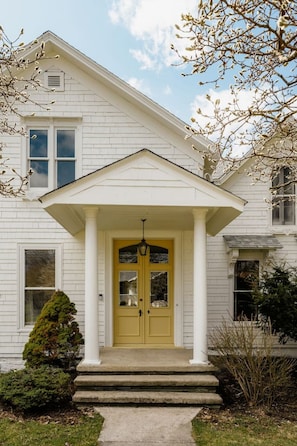 The charming front entrance of The Wright House welcomes you to a historic lakeside retreat