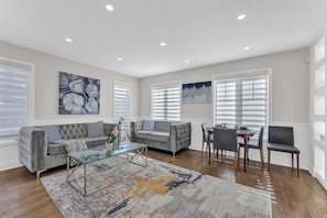 Soft grey tones and natural light fill this cozy modern interior.