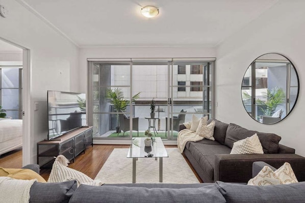 A spacious living with a 3-seater sofa bed that folds out to a double and a 3-seater couch.