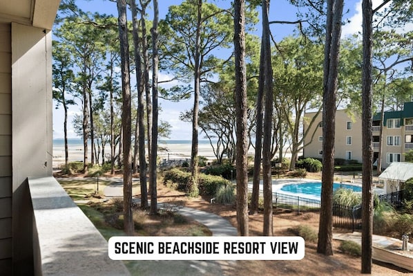 Your great view from balcony with pool. This area is beautifully lined with oak and pine trees.