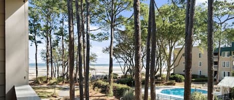Your great view from balcony with pool. This area is beautifully lined with oak and pine trees.