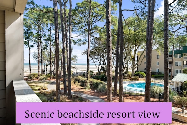 Your great view from balcony with pool. This area is beautifully lined with oak and pine trees.