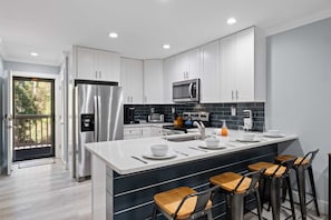 Large Slab of Quartz makes for delightful eating area.