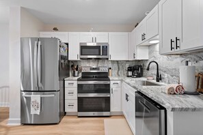 The kitchen has illuminated by ample lighting. 