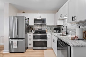 The kitchen has illuminated by ample lighting.