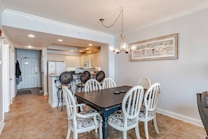 Dining area with table and 6 chairs and bar seating for 3