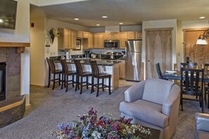 1098 Square Feet - Fireplace - Living Room - Dining Table - Bar Stools