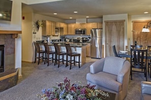 1098 Square Feet - Fireplace - Living Room - Dining Table - Bar Stools