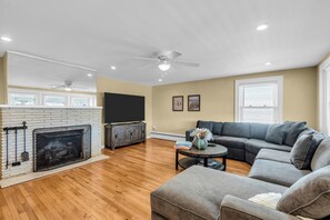 Huge living room with sectional and 75 inch brand new smart tv