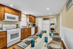 Coastal kitchen with 6 seat table with bench seating for comfort and convenience!