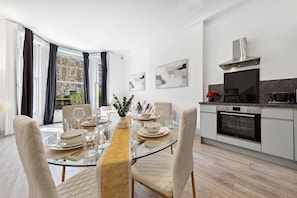 Dine in style with natural light, elegant decor, and a fully equipped kitchen - perfect for cozy meals or entertaining in the city