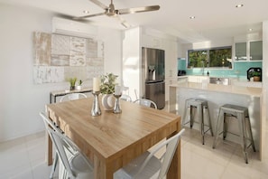 Start the morning with coffee at the sleek breakfast island — perfect for light bites, lazy chats, or planning your day on the coast.