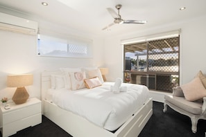 Rest easy in the primary suite, featuring a queen bed, blackout blinds and ensuite access.