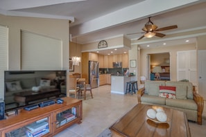 Bright, open-concept living space with golf course views and ample room to gather after island adventures.