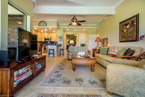 Bright, open-concept living space with golf course views and ample room to gather after island adventures.