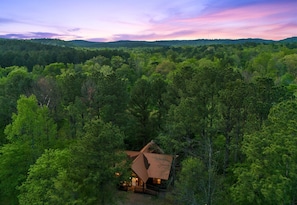 Drift above the treetops and see how your cabin nestles peacefully into its beautiful, private forest setting.