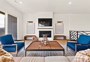 Relax and recharge in this cozy living room, where comfy seating and a warm, welcoming vibe invite you to kick back and stay awhile.