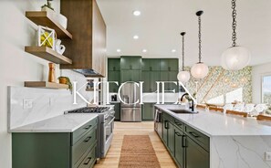 Gorgeous, sleek kitchen stocked with everything you need for home-cooked meals, late-night snacks, or happy hour appetizers.
