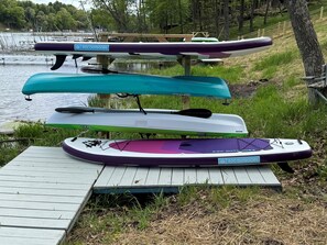 The paddleboards and kayaks are ready and waiting—just grab one and head out for a peaceful glide across the water.