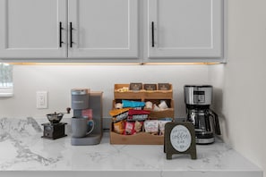 Start your mornings at the full coffee bar—stocked with everything from single-serve pods and a fresh bag of coffee to syrups, creamer, and sugar. Just pick your favorite, brew, and sip into relaxation.