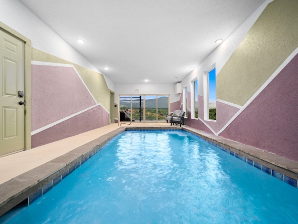 Enjoy an expansive indoor pool with incredible mountain view! The hot tub is right on the deck.