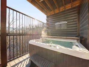 Unwind in the hot tub while soaking in the stunning mountain views for the ultimate relaxation.