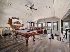 Have fun and unwind in the game room, complete with entertaining activities and stunning mountain views