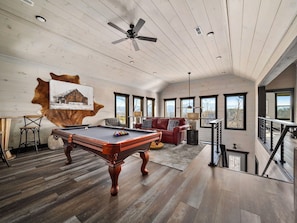 Have fun and unwind in the game room, complete with entertaining activities and stunning mountain views