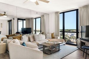 Comfortable living room seating with Smart TV, sound bar, and subwoofer.