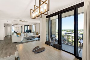 The dining room table sits next to the patio and balcony.