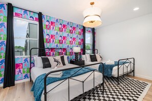 3rd Floor: Primary Bedroom with two queen beds, a Smart TV, Elvis-themed accent wall, and an en-suite bathroom.