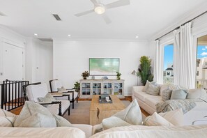Living room features plenty of seating with a smart tv, perfect for entertaining.