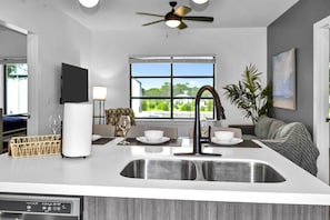 Kitchen area with all stainless steel appliances - microwave, Keurig pod coffee maker, dishwasher, range & refrigerator!