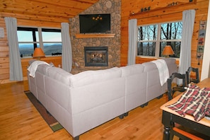 Comfy couch, gas log fireplace, smart tv and mountain views