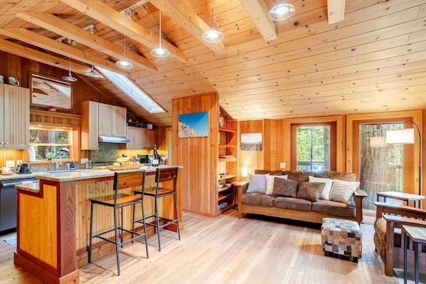 Cozy living room with desk and serene forest views