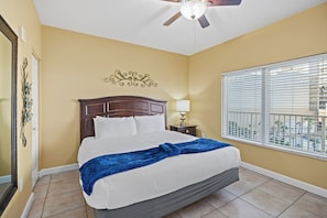 Primary bedroom with king bed and warm golden tones.