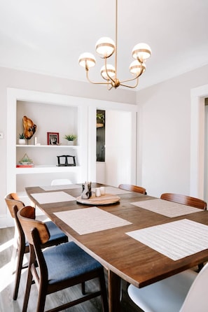 Dining table can comfortably accomodate 8 but fits 10 people with the additional leaf.