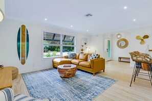Enjoy this modern living room with a smart streaming TV, Lutron lighting, Sonos indoor/outdoor sound system, and impact windows for added comfort and quiet. A personal desk makes it easy to work or unwind in style.