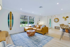 Enjoy this modern living room with a smart streaming TV, Lutron lighting, Sonos indoor/outdoor sound system, and impact windows for added comfort and quiet. A personal desk makes it easy to work or unwind in style.