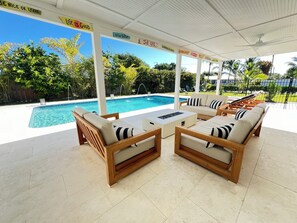 Unwind at this sunny retreat with a heated saltwater pool and stylish outdoor lounge patio — perfect for relaxing, grilling, and soaking up the Florida vibes.